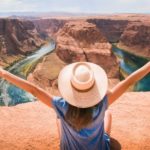 Woman sitting on overlooking mountain