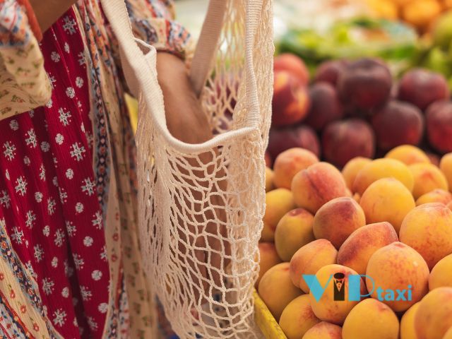 earth-day-events-reusable-bag-shopping Woman Shopping with a Reusable Bag at a Market, Supporting Sustainability and Earth Day Events.